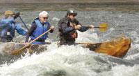 MTSTD paddling rapids in dugout canoe.