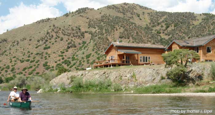Houses crowding Jefferson River, MT.